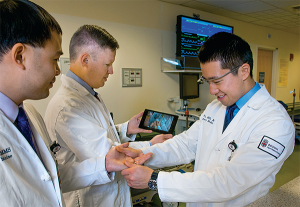 Rhode Island Hospital emergency physicians Peter Chai, MD, Paul Porter, MD, and Roger Wu, MD, (left to right) test Google Glass’s real-time video capabilities.