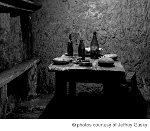 French soldiers’ dining area underground with wine bottles, canteens, and a serving dish. Photographed Dec. 6, 2011. Vauquois, France.