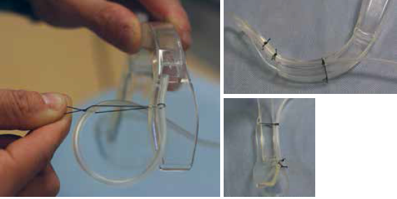 Figure 5. Fasten the IV tubing to the laryngoscope blade with 0-0 silk with the knot tied on the lateral aspect of the laryngoscope.