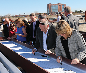 ACEP Board members sign a beam for the building.