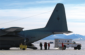 An ambulance delivers a patient to a medevac plane. 